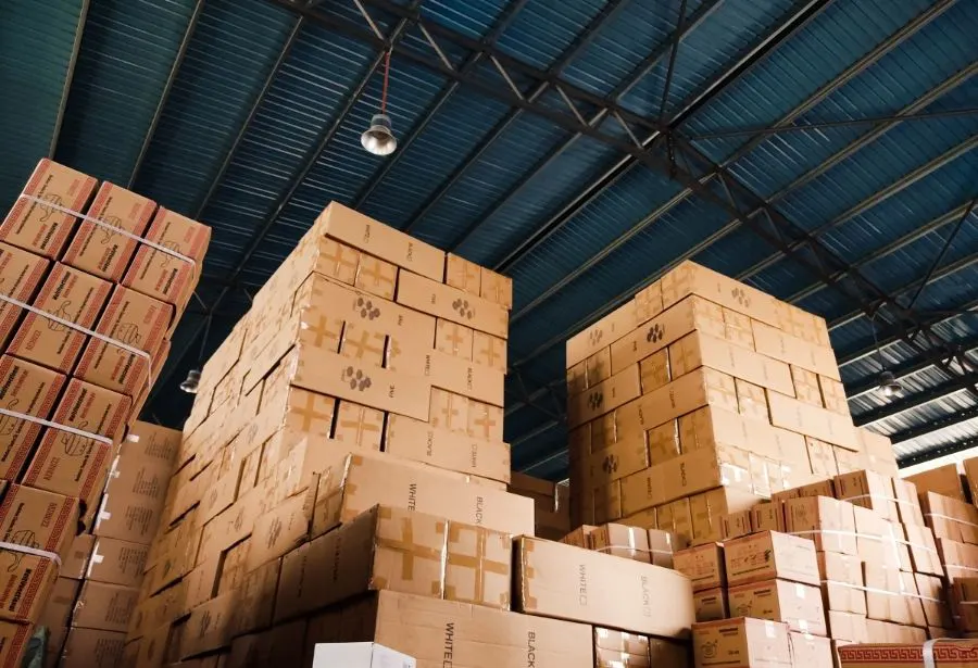 Stacked inventory boxes stored in a warehouse facility