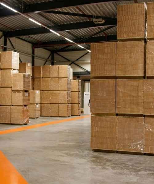 tacked cardboard pallets inside a warehouse storage facility ready for distribution and fulfillment